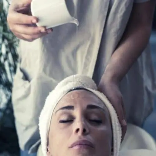 Close-up of a woman undergoing a facial cleansing treatment. Facial cleansing.
